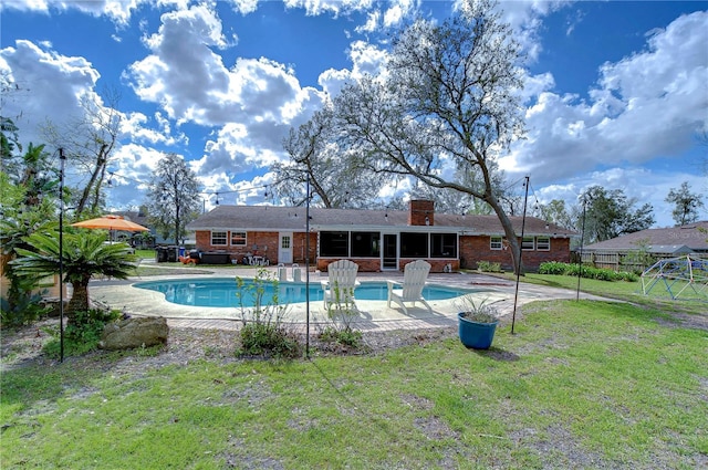 view of pool with a fenced in pool, a sunroom, a patio area, and a yard