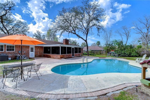 outdoor pool with a sunroom, a patio, and fence