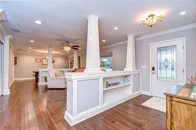 entryway featuring ornate columns, ceiling fan, dark wood-style floors, and a textured ceiling