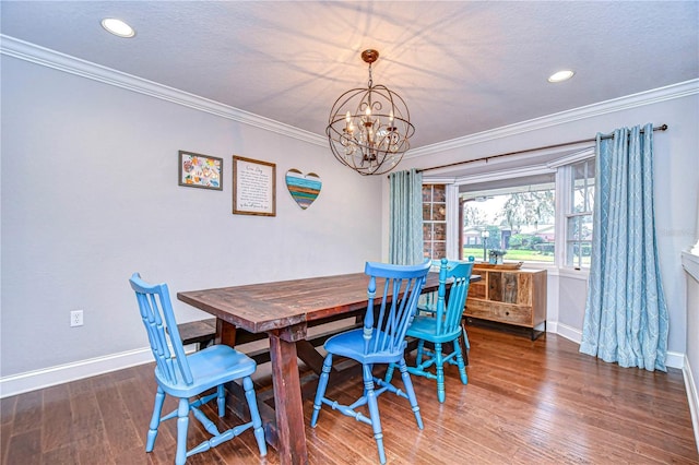 dining space featuring baseboards, ornamental molding, and wood finished floors