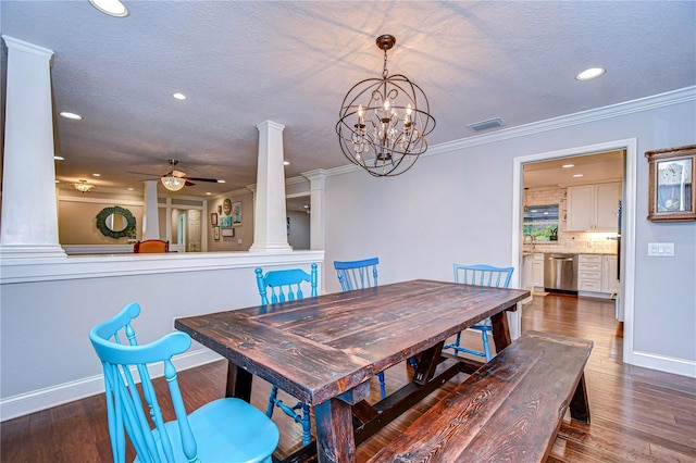 dining area with visible vents, wood finished floors, crown molding, ornate columns, and ceiling fan with notable chandelier