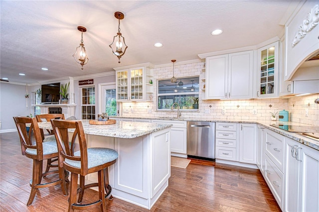 kitchen featuring tasteful backsplash, dark wood-style flooring, white cabinets, and dishwasher