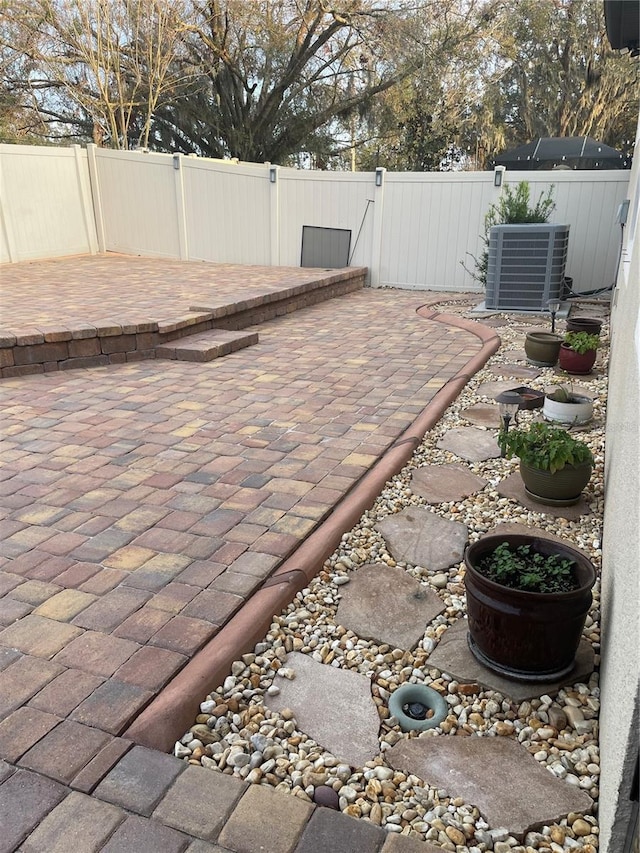 view of patio featuring fence and cooling unit