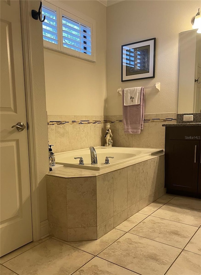 bathroom with tile patterned flooring, a bath, and vanity