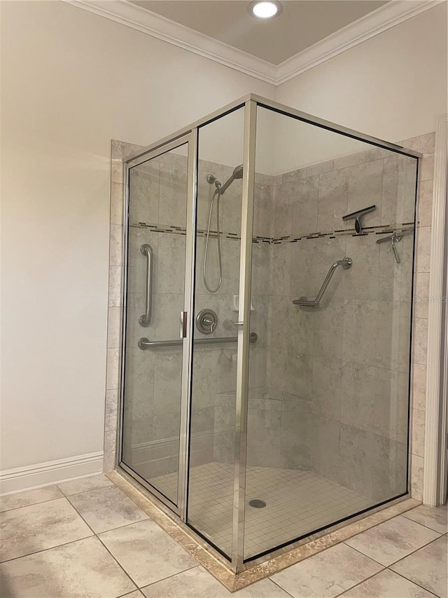 full bathroom featuring ornamental molding, a stall shower, tile patterned flooring, and baseboards