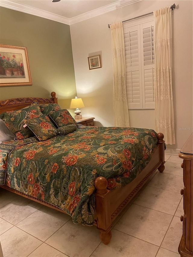 bedroom with crown molding and light tile patterned floors