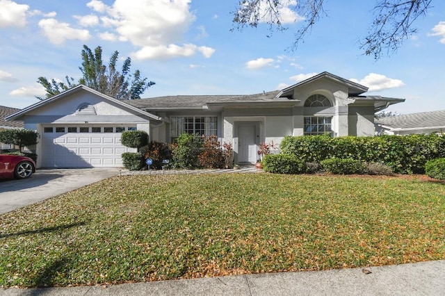 ranch-style home with concrete driveway, a front lawn, an attached garage, and stucco siding