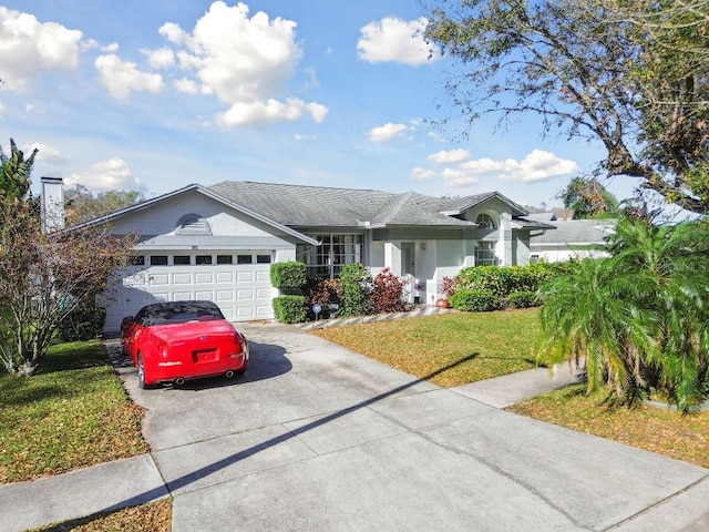 ranch-style house with a garage, a front yard, concrete driveway, and stucco siding