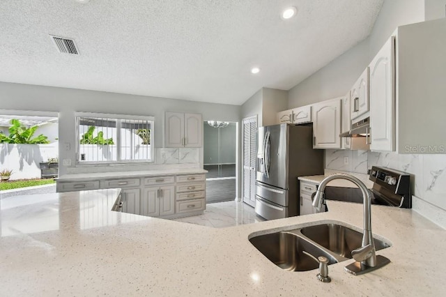 915 Brittany Park Blvd, Tarpon Springs, FL 34689 - kitchen with a sink, stainless steel appliances, under cabinet range hood, light stone countertops, and tasteful backsplash