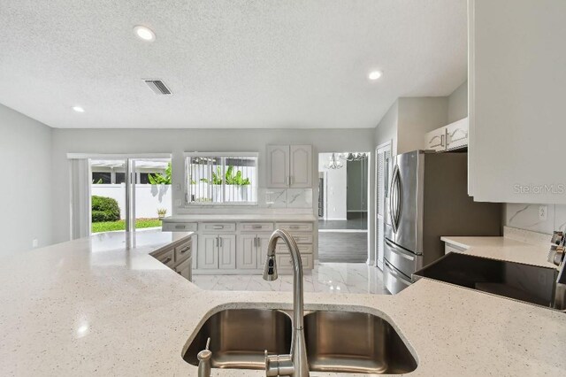 915 Brittany Park Blvd, Tarpon Springs, FL 34689 - kitchen with a sink, light stone countertops, range, recessed lighting, and a textured ceiling