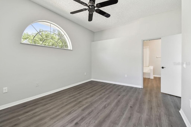 915 Brittany Park Blvd, Tarpon Springs, FL 34689 - unfurnished room with a textured ceiling, dark wood-type flooring, a ceiling fan, and baseboards