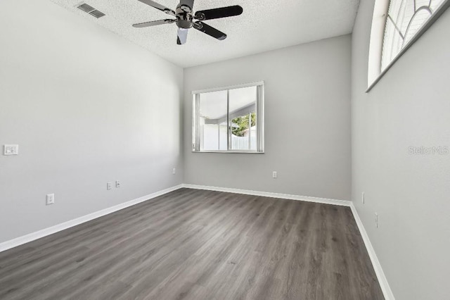 915 Brittany Park Blvd, Tarpon Springs, FL 34689 - empty room featuring dark wood finished floors, a textured ceiling, a ceiling fan, and baseboards