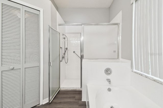915 Brittany Park Blvd, Tarpon Springs, FL 34689 - full bath with a garden tub, a closet, a shower stall, and wood finished floors