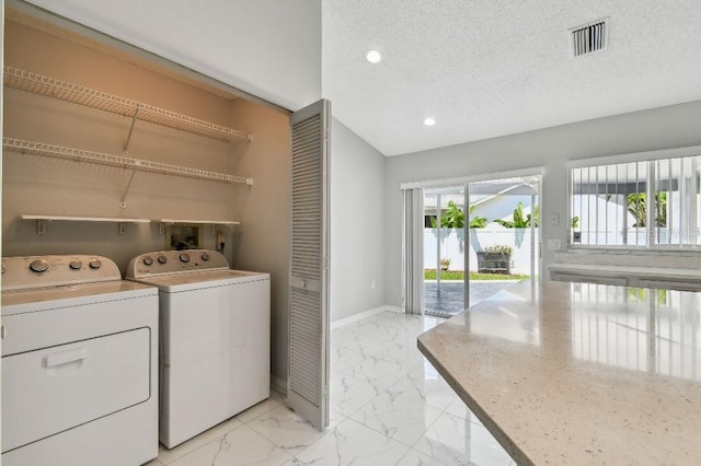 915 Brittany Park Blvd, Tarpon Springs, FL 34689 - laundry room with independent washer and dryer, baseboards, light marble finish floors, recessed lighting, and a textured ceiling
