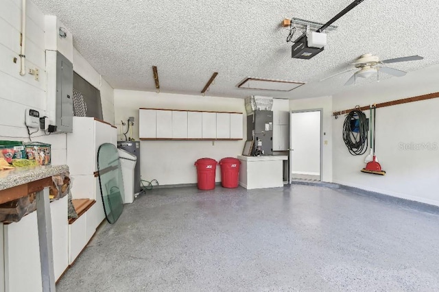 915 Brittany Park Blvd, Tarpon Springs, FL 34689 - garage with heating unit, electric panel, water heater, a garage door opener, and baseboards