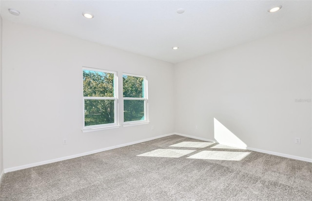 carpeted spare room with baseboards and recessed lighting