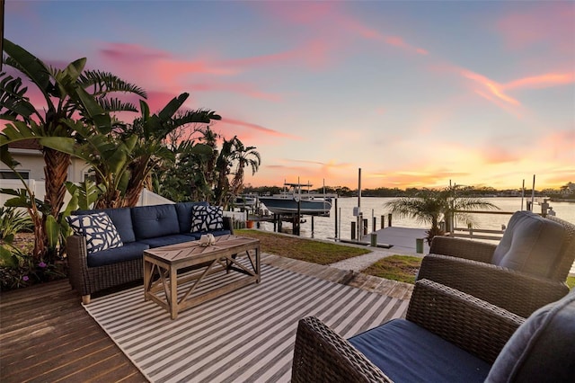 wooden terrace with a boat dock, an outdoor living space, a water view, and boat lift