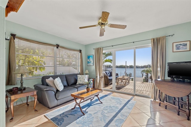 living area featuring light tile patterned floors and a ceiling fan