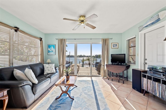 living area featuring tile patterned floors and ceiling fan