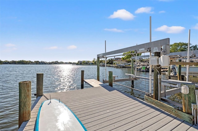 view of dock featuring a water view and boat lift