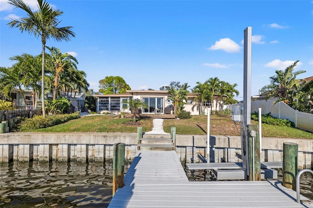 view of dock featuring a yard and fence