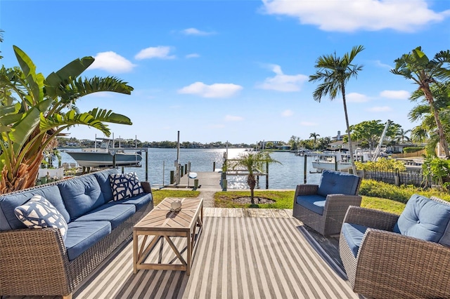 exterior space with outdoor lounge area, a dock, a water view, and boat lift