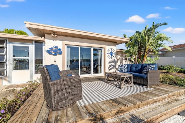 deck with an outdoor hangout area and fence