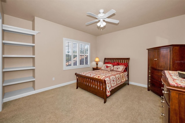 bedroom featuring light carpet, baseboards, and a ceiling fan