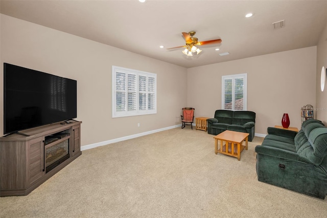 living area featuring ceiling fan, recessed lighting, light carpet, visible vents, and baseboards