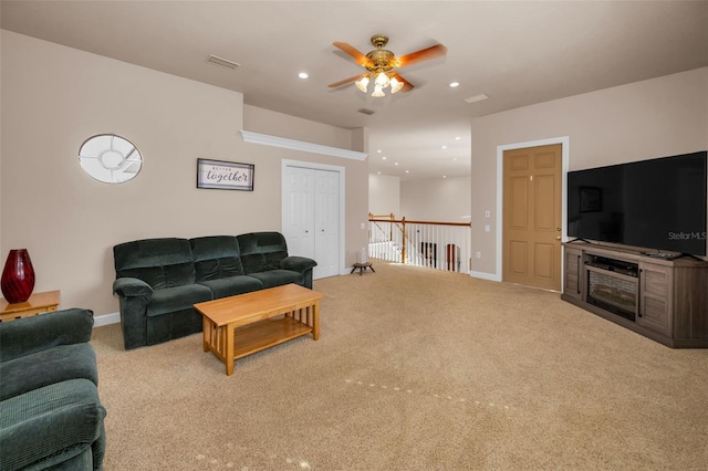 living area with recessed lighting, carpet floors, a ceiling fan, baseboards, and visible vents