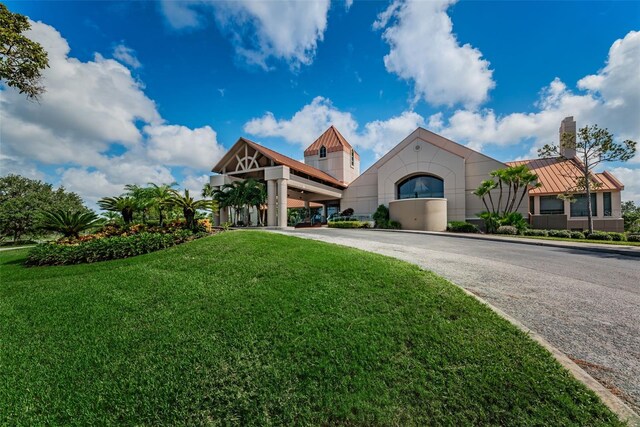 view of front of house with a front yard, a standing seam roof, and metal roof