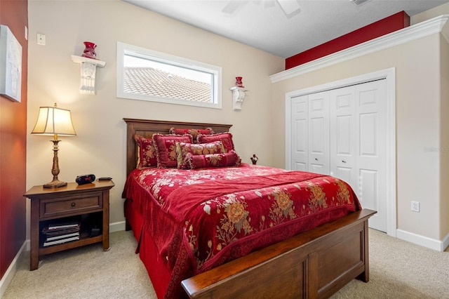 bedroom featuring baseboards, ceiling fan, a closet, and light colored carpet