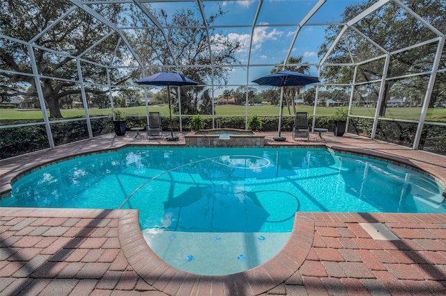 view of pool featuring glass enclosure, a patio area, and a pool with connected hot tub