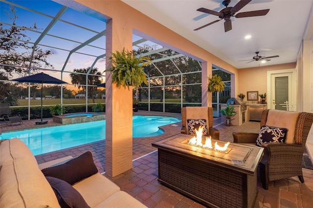 outdoor pool featuring a lanai, an in ground hot tub, exterior kitchen, and a patio