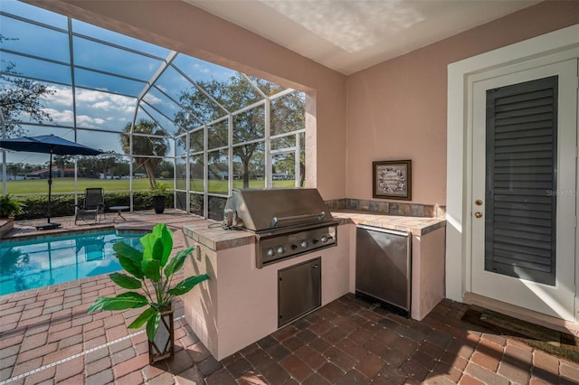 view of patio with glass enclosure, grilling area, an outdoor kitchen, and an outdoor pool