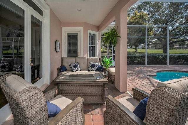 view of patio / terrace featuring a lanai, an outdoor pool, and an outdoor hangout area