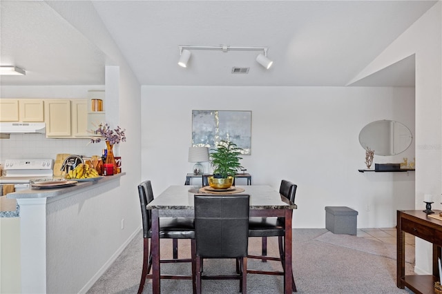 dining room with track lighting, visible vents, and carpet flooring