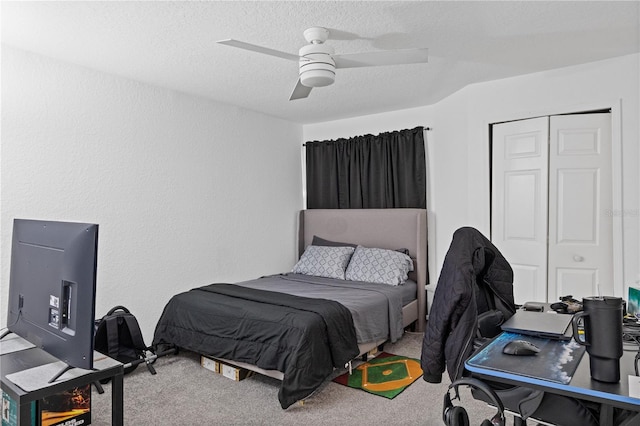 bedroom featuring a textured ceiling, a closet, carpet flooring, and a ceiling fan