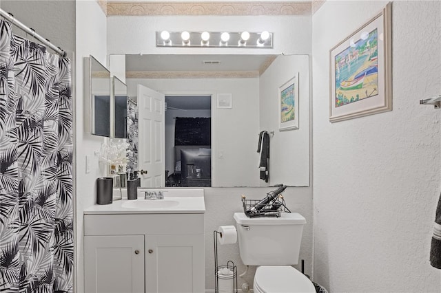 bathroom with visible vents, a textured wall, a shower with shower curtain, toilet, and vanity