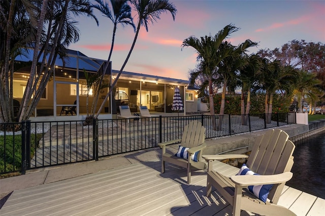 deck featuring a lanai, fence, and a patio