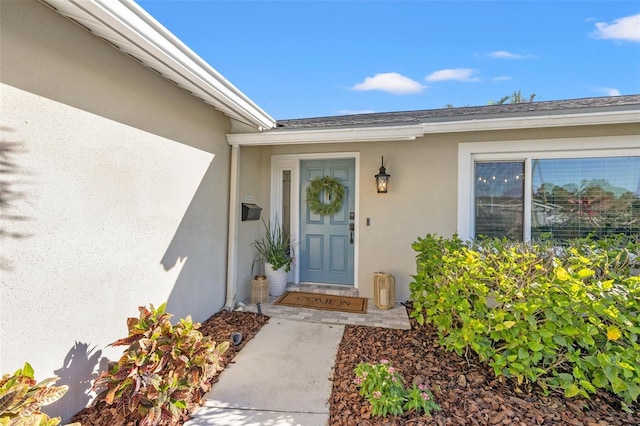 view of exterior entry featuring stucco siding