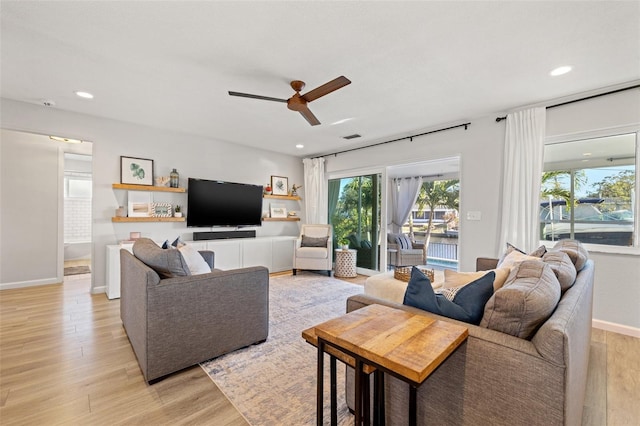 living area with recessed lighting, a ceiling fan, light wood-style floors, and baseboards