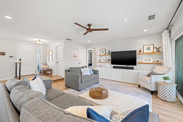 living room with visible vents, recessed lighting, light wood-type flooring, and ceiling fan