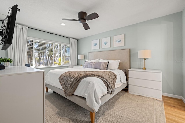 bedroom featuring recessed lighting, baseboards, light wood-type flooring, and ceiling fan