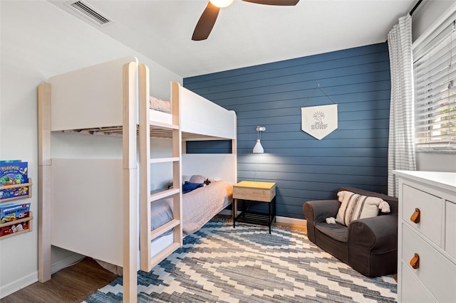 bedroom featuring visible vents, baseboards, ceiling fan, and light wood-style flooring