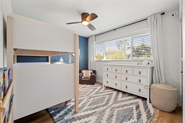 bedroom featuring wood finished floors and a ceiling fan