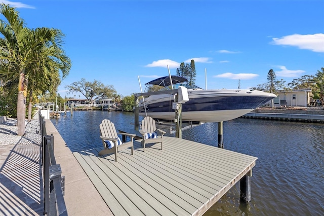 dock area with boat lift and a water view