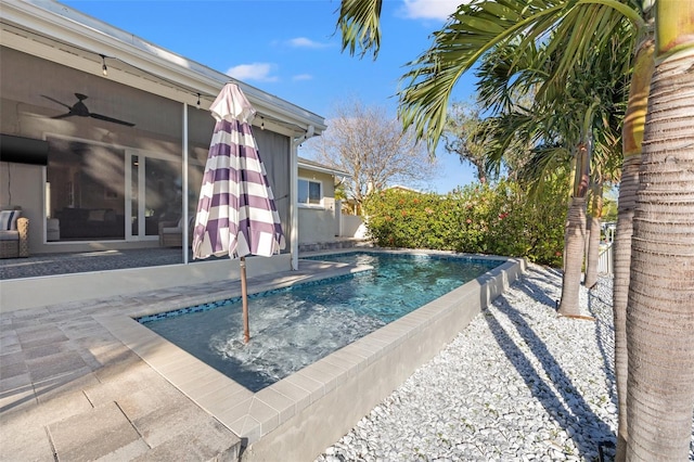 outdoor pool with a patio, ceiling fan, and fence