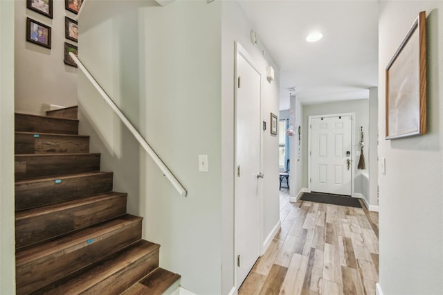 stairs featuring recessed lighting, baseboards, and wood finished floors