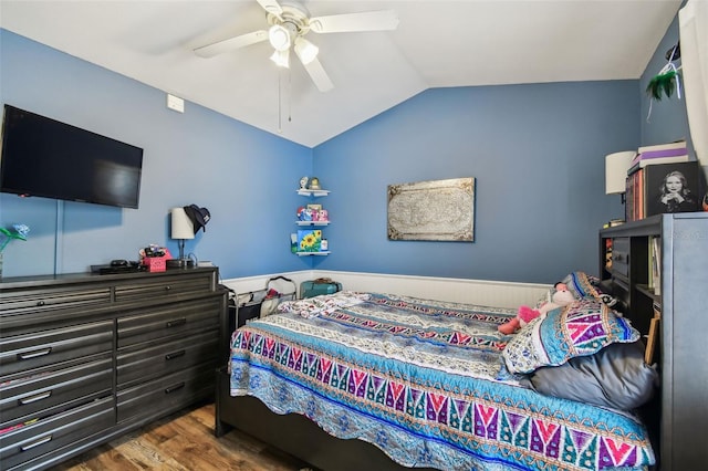 bedroom featuring dark wood-style floors, vaulted ceiling, and a ceiling fan